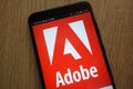 Adobe logo displayed on a modern smartphone