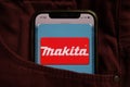 KONSKIE, POLAND - September 04, 2021: Makita Corporation logo on mobile phone hidden in jeans pocket