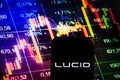 KONSKIE, POLAND - September 10, 2022: Smartphone displaying logo of Lucid Motors company on stock exchange chart background