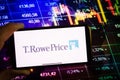 KONSKIE, POLAND - September 10, 2022: Smartphone displaying logo of T. Rowe Price company on stock exchange chart background