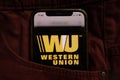 KONSKIE, POLAND - September 04, 2021: Western Union Company logo on mobile phone hidden in jeans pocket
