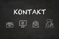 `Kontakt` text and icons on a blackboard. Translation: `Contact`