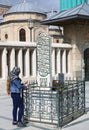 Unidentified Turkish Woman with Scarf praying at Old Ottoman Era Grave behind the  Mevlana Museum Mosque Royalty Free Stock Photo