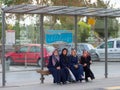 Smiling Muslim women sitting at the tram stop in Konya city, Trukey