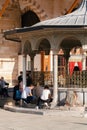 People taking ablution, drinking water in the fountain of the Mevlana Mausoleum in Mevlana Square in Konya