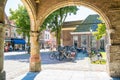 Koorstraat shops, people and arcades of church in Alkmaar, Nethe