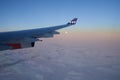 KOPENHAGEN, DENMARK - 24 NOV 2018: View from the aircraft cabin to the wing at sunset over the icebergs of Greenland Royalty Free Stock Photo