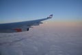 KOPENHAGEN, DENMARK - 24 NOV 2018: View from the aircraft cabin to the wing at sunset over the icebergs of Greenland Royalty Free Stock Photo