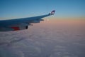 KOPENHAGEN, DENMARK - 24 NOV 2018: View from the aircraft cabin to the wing at sunset over the icebergs of Greenland Royalty Free Stock Photo