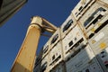 Cream color cargo crane between white reefers containers lashed and secured with twist locks and lashing bars. Royalty Free Stock Photo