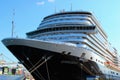 Close up view of mooring ropes that goes to the bow of huge luxury cruise ship. Travel and tourism concept.