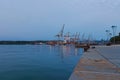 Scenic evening landscape view of Harbor of Koper. Many cranes in the background