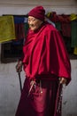 A Tibetan Buddhist Nun kora the Stupa and praying , Nepal