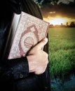 Koran in hand - holy book of Muslims  public item of all muslims Royalty Free Stock Photo