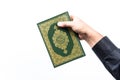 Koran in hand ,Quran in hand - holy book of Muslims , on white background Royalty Free Stock Photo