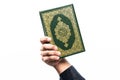 Koran in hand ,Quran in hand - holy book of Muslims , on white background Royalty Free Stock Photo