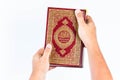 Koran in hand ,Quran in hand - holy book of Muslims , on white background Royalty Free Stock Photo