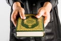 Koran in hand ,Quran in hand - holy book of Muslims , on white background Royalty Free Stock Photo