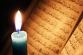 Koran or quran holy book with candle on candlelight Royalty Free Stock Photo