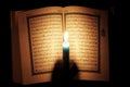 Koran or quran holy book with candle on candlelight Royalty Free Stock Photo