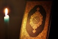 Koran or quran holy book with candle Royalty Free Stock Photo