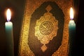 Koran or quran holy book with candle Royalty Free Stock Photo