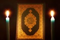 Koran or quran holy book with candle Royalty Free Stock Photo