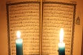 Koran or quran holy book with candles Royalty Free Stock Photo