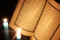 Koran or quran holy book with candles Royalty Free Stock Photo