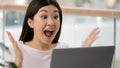 Korean Asian woman with laptop luck excited surprised feels very happy got university scholarship win online auction