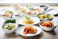 korean banchan side dishes assortment with kimchi as centerpiece Royalty Free Stock Photo