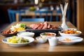 korean bbq grill table with side dishes Royalty Free Stock Photo