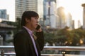 Korean businessman phone call in city at sunset Royalty Free Stock Photo