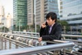 Korean Businessman talking over phone in city Royalty Free Stock Photo