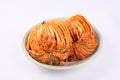 Korean cabbage kimchi on plate on white background