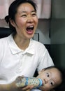 Korean child with his mother Royalty Free Stock Photo
