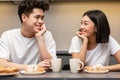 Korean Couple Drinking Morning Coffee And Eating Breakfast In Kitchen Royalty Free Stock Photo