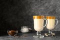 Korean Dalgona coffee in tall glass mugs. Trendy refreshment creamy whipped iced coffee.