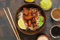 Korean dish of noodles with fried meat and vegetables. Asian food, on an old rusty background. View from above.