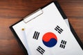 Korean document, mockup for text on clipboard, white sheet of paper in a folder for notes with flag of Korea Royalty Free Stock Photo