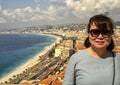 Korean female tourist with view of Nice and the Bay of Angels, France