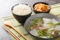 Korean food beef radish soup which is called soegogi muguk served with rice and kimchi closeup on the mat. Horizontal