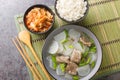 Korean food beef radish soup which is called soegogi muguk served with rice and kimchi closeup on the mat. Horizontal top view