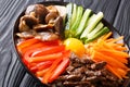 Korean food Bibimbap with fried beef, raw egg, vegetables, shiitake and rice close-up in a bowl. horizontal Royalty Free Stock Photo