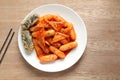 Korean food, Rice cake stick in a spicy gochujang sauce and fish cakes. Tteokbokki in white plate. Royalty Free Stock Photo