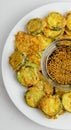 Korean fried zucchini on white plate with a sesame soy dipping sauce