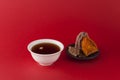 Korean fruit punch or tea - Sujeonggwa on a red background with gradient. It is made from dried persimmons with pine nuts