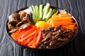 Korean healthy food Bibimbap of rice with fried beef, raw egg, v