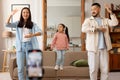 Korean influencers parents and little daughter dancing shooting video indoor