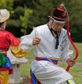 Korean Man in Headdress Dancing at Cultural Celebration